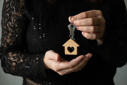 New home owner holding keys in her hand, representing a property purchase or rental.