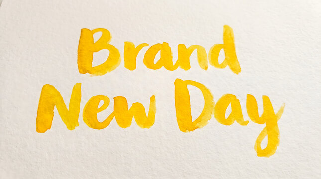 Vibrant Yellow Watercolor Typography on White Paper