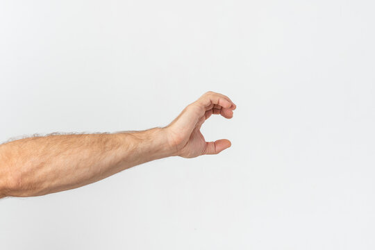 Male hand with arm extended creating a small gesture, symbolizing exact size, measurement, or grasping an invisible object against a clean white background