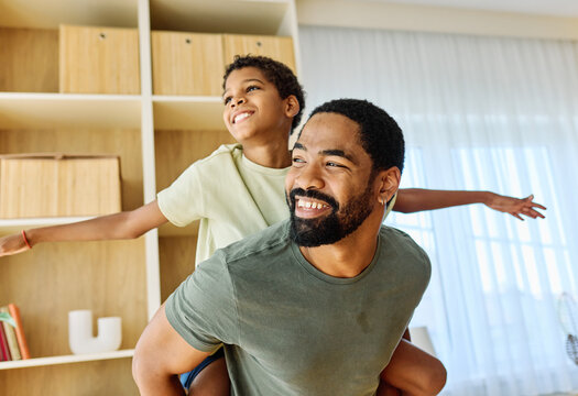 Portrait of father and son having fun at home, family life, parenting, love and bonding concepts