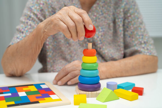 Asian elderly woman playing game.