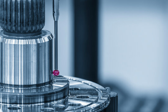 Close-up of a touching probe measuring automotive metal parts in a blue tone scene