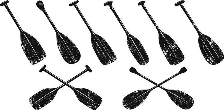 set of black and white vintage canoe paddles, various angles and crossed designs