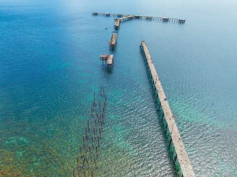 Sections of an old abandoned jetty alongside a new replacement