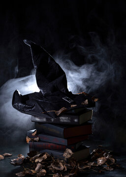 black witch hat on a stack of books