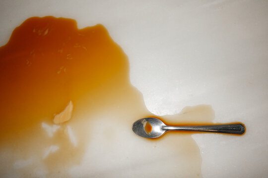 Spilled coffee with Spoon on Table