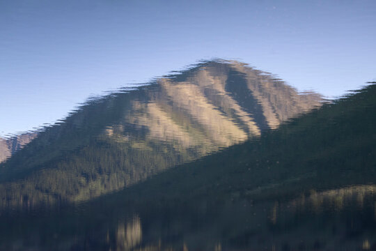 Reflection of sun shining on mountain on a summer day in Alaska.