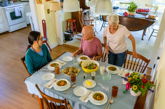 Caregiver senior couple enjoy meal together