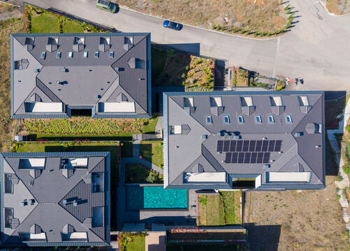 Aerial View Of Luxury Villas With Pool And Solar Panels