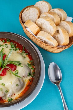 Meatballs with bread and spoon on blue