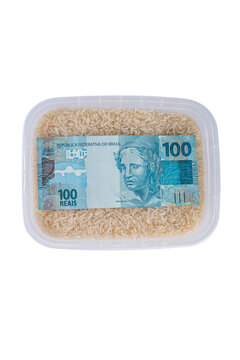 Rice in container with 100 reais bill