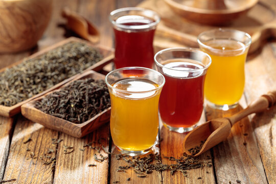Black and green tea in small glass cups.