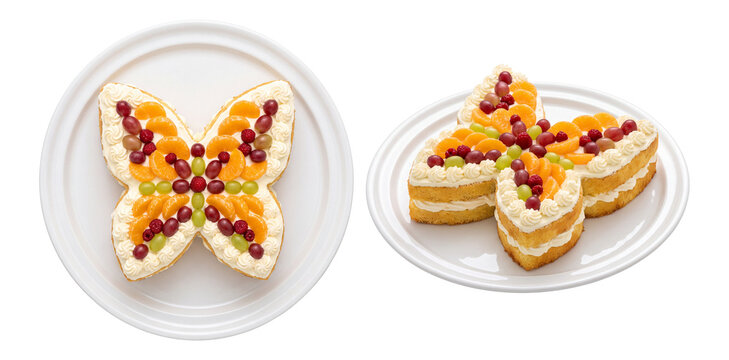 sponge cake decorated with fresh fruits and cream shaped like a butterfly