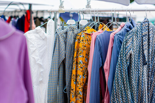 Various clothes hanging on rack