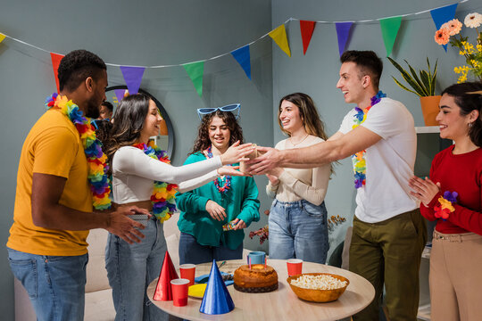 group of multicultural friends celebrating a birthday, Diverse group of people having fun in a party at home