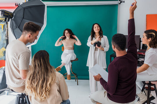 group of young hispanic students of photography in studio, photographers learning in workshop