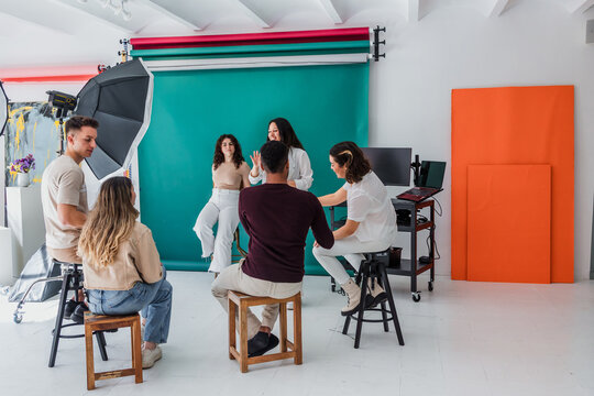 group of young hispanic students of photography in studio, photographers learning in workshop