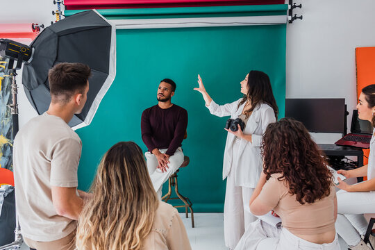 group of young hispanic students of photography in studio, photographers learning in workshop
