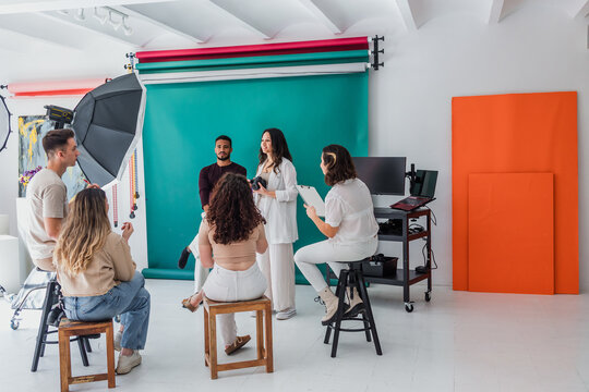 group of young hispanic students of photography in studio, photographers learning in workshop