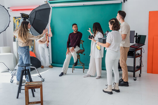 group of young hispanic students of photography in studio, photographers learning in workshop