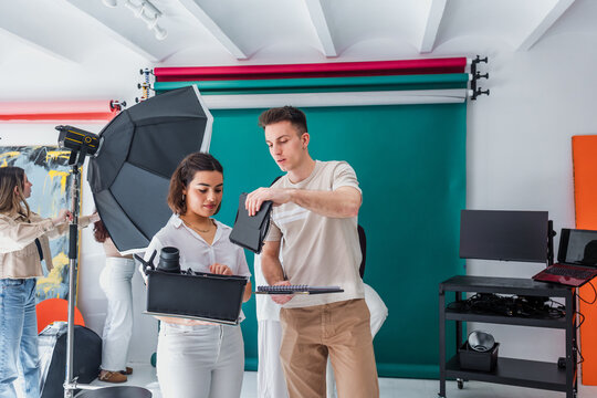 group of young hispanic students of photography in studio, photographers learning in workshop