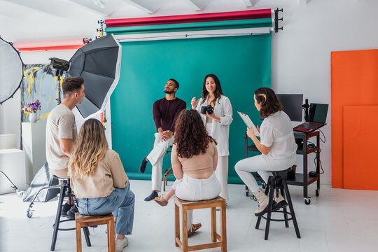 group of young hispanic students of photography in studio, photographers learning in workshop