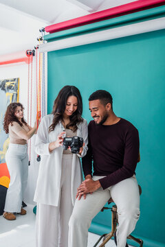 group of young hispanic students of photography in studio, photographers learning in workshop