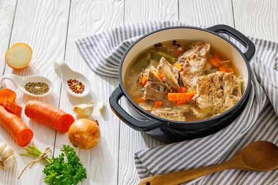 Rich pork rib bone broth in a black pot