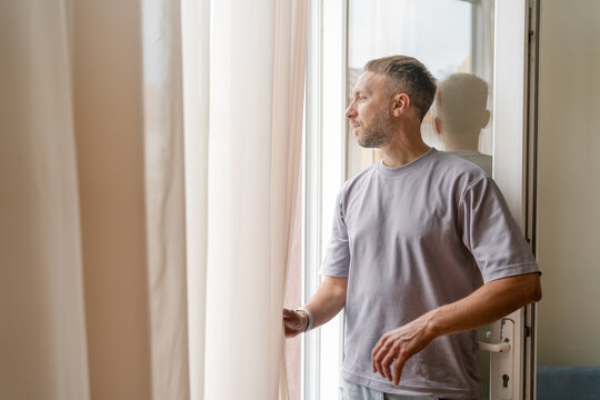 Hope and New Beginnings, Optimistic Man Looking Through Window and Reflecting on Positive Future.
