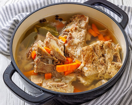 Rich pork rib bone broth in a black pot