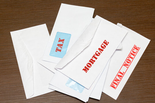 Pile of bills envelopes with large red letters warnings with final notice for unpaid bills