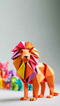 A colorful geometric paper lion sculpture stands prominently with more vibrant origami animals blurred in the background on a neutral surface.