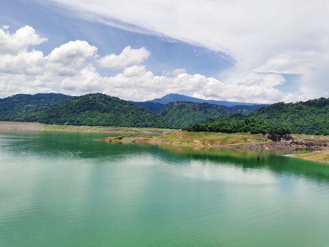 Khun Dan Prakarn Chon Dam with emerald water and green mountains in Nakhon Nayok, Thailand.