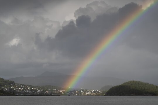 Dramatic lighting, dark clouds, rainbows, near &Aring;lesund or Alesund, M&oslash;re og Romsdal county, Norway