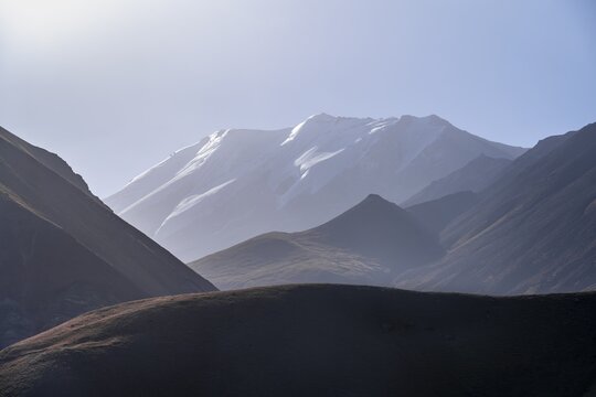 Mountains reflected in a small mountain lake, Pik Lenin, Trans Alay Mountains, Pamir Mountains, Osh Province, Kyrgyzstan