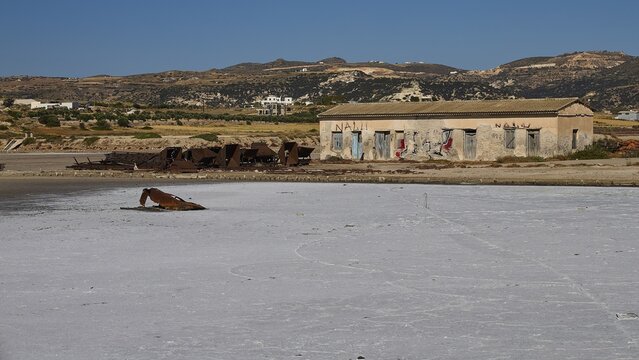 Abandoned building with graffiti against dry landscape and hills, saltworks, Lost Place, near airport, salt lake, Alykes Milou, Milos, Cyclades, Greek Islands, Greece
