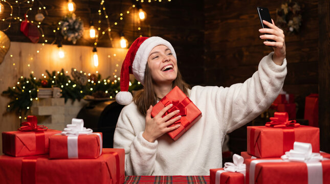 Christmas shopping wishlist gift woman selfie smartphone santa hat happy holiday moment. Happy new year festive holiday joy special christmas gift present gift wish list planning checklist