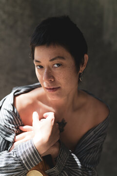 Intimate portrait of a person with freckles and short hair