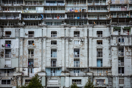 Aging Housing Infrastructure, Deteriorating Apartment Building with Crumbling Facade and Urban Decay.
