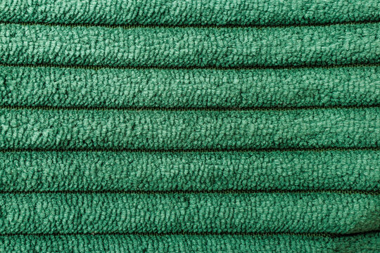 Green ribbed upholstery fabric with repeating woven texture