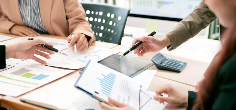 Close Up of Business Team Analyzing Financial Reports and Data in Office Meeting