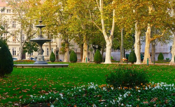 City park with fountain, trees and colorful flowers, peaceful places background, Zagreb, Croatia
