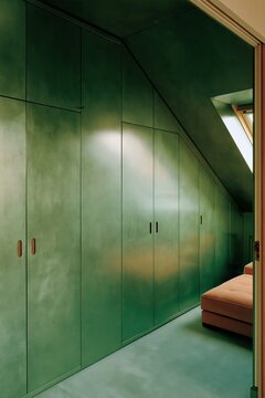 Olive green attic storage cabinets with walnut pulls, color drenching interior design for compact flat, home renovation