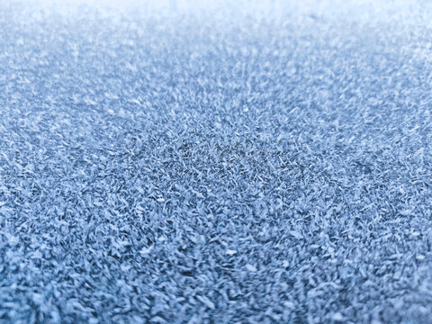 Ice crystals forming an intricate textured surface