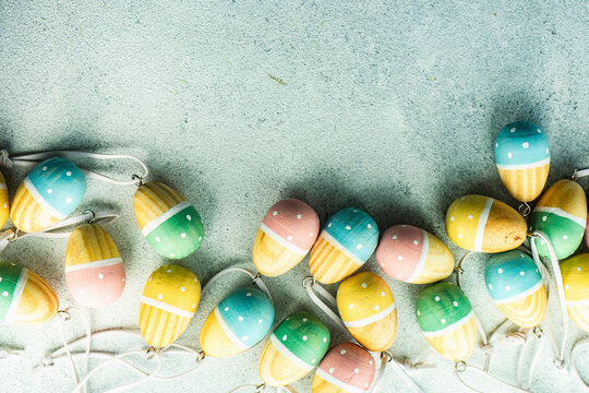 Wooden painted easter eggs in a spring holiday frame