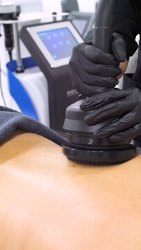 Professional body shaping therapy with vibromassage thermo vacuum and bioelectrical stimulation in beauty salon. 
