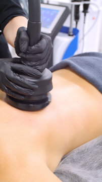 Professional body shaping therapy with vibromassage thermo vacuum and bioelectrical stimulation in beauty salon. 