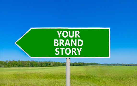 Branding and your brand story symbol. Concept words Your brand story on beautiful green road sign. Beautiful blue sky green grass background. Business branding your brand story concept. Copy space.