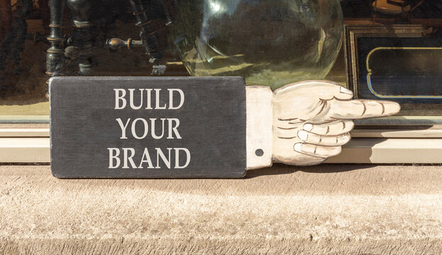 Build your brand words symbol. Concept words Build your brand on beautiful black information sign. Beautiful shopfront background. Business and build your brand concept. Copy space.