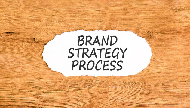 Brand strategy process words symbol. Concept words Brand strategy process on beautiful white paper. Beautiful wooden background. Business and brand strategy process concept. Copy space.